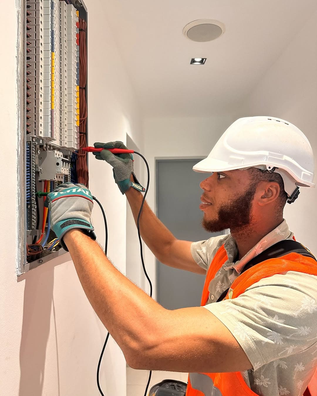 Safety inspector checking electrical distribution board in Ghana
